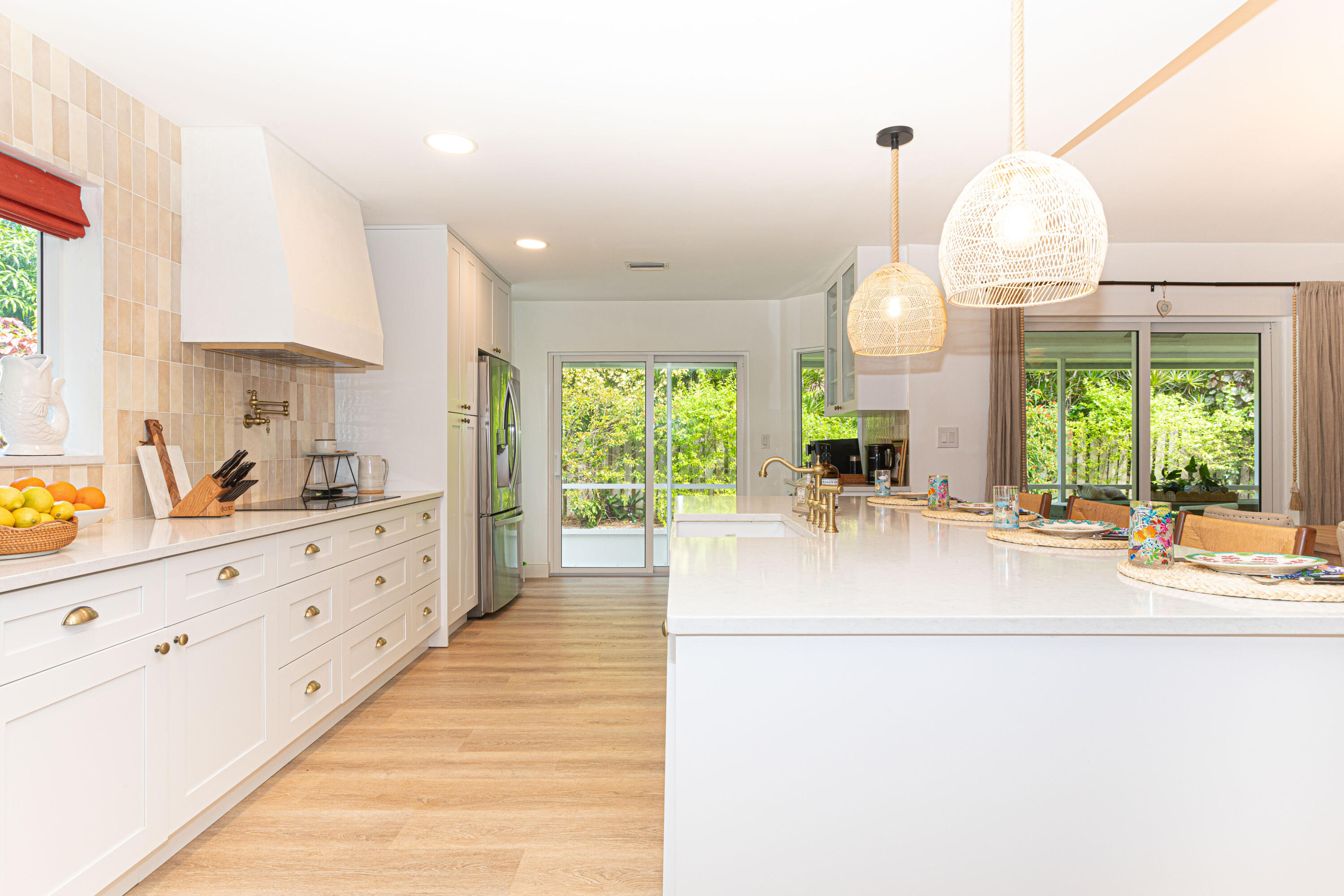 2477 Par Circle Delray Beach, FL 33445 - Photo 11 of 34 a large white kitchen with granite countertop a large window and white cabinets