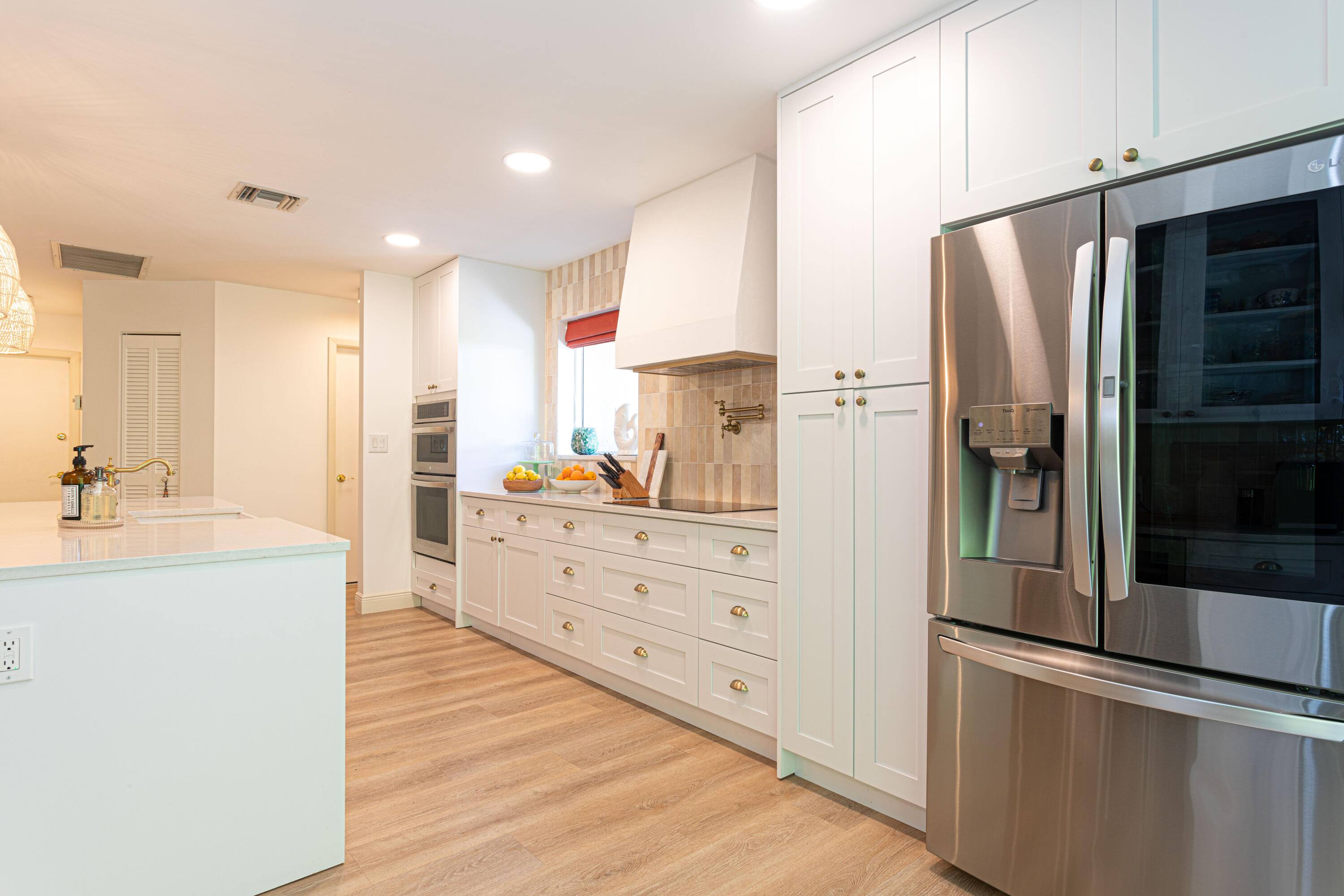 2477 Par Circle Delray Beach, FL 33445 - Photo 12 of 34 a kitchen with stainless steel appliances a refrigerator sink and cabinets