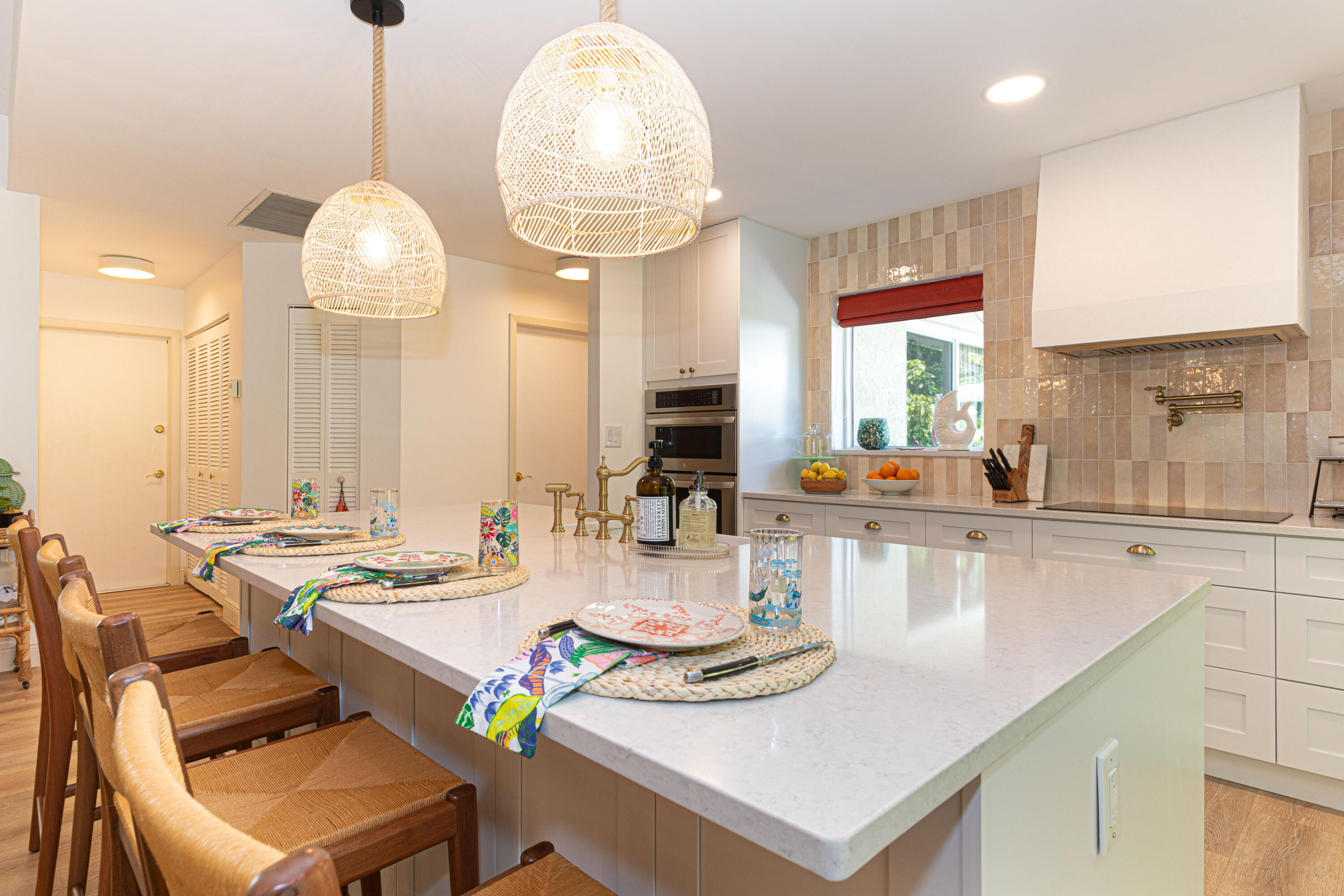 2477 Par Circle Delray Beach, FL 33445 - Photo 14 of 34 a kitchen with a table chairs and a chandelier