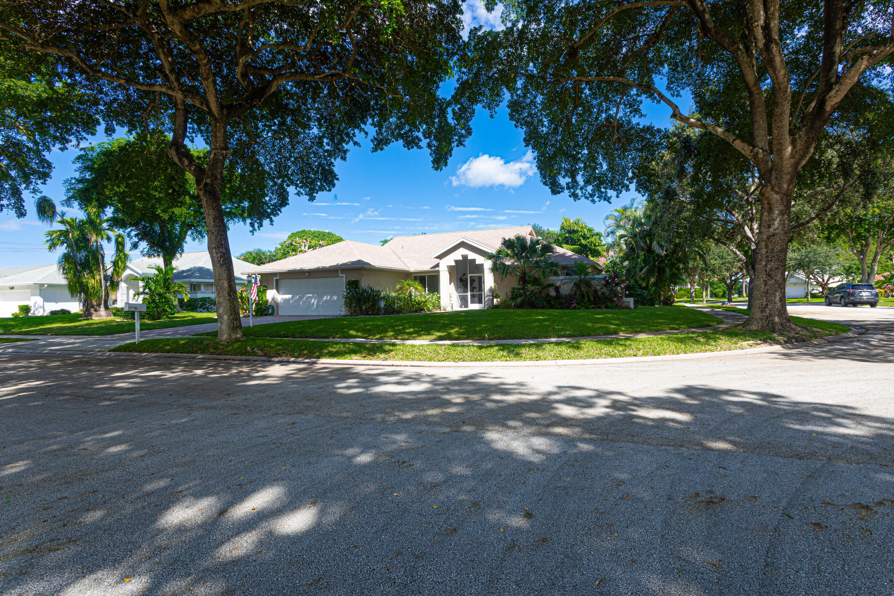 2477 Par Circle Delray Beach, FL 33445 - Photo 2 of 34 a view of a house with a yard and tree s
