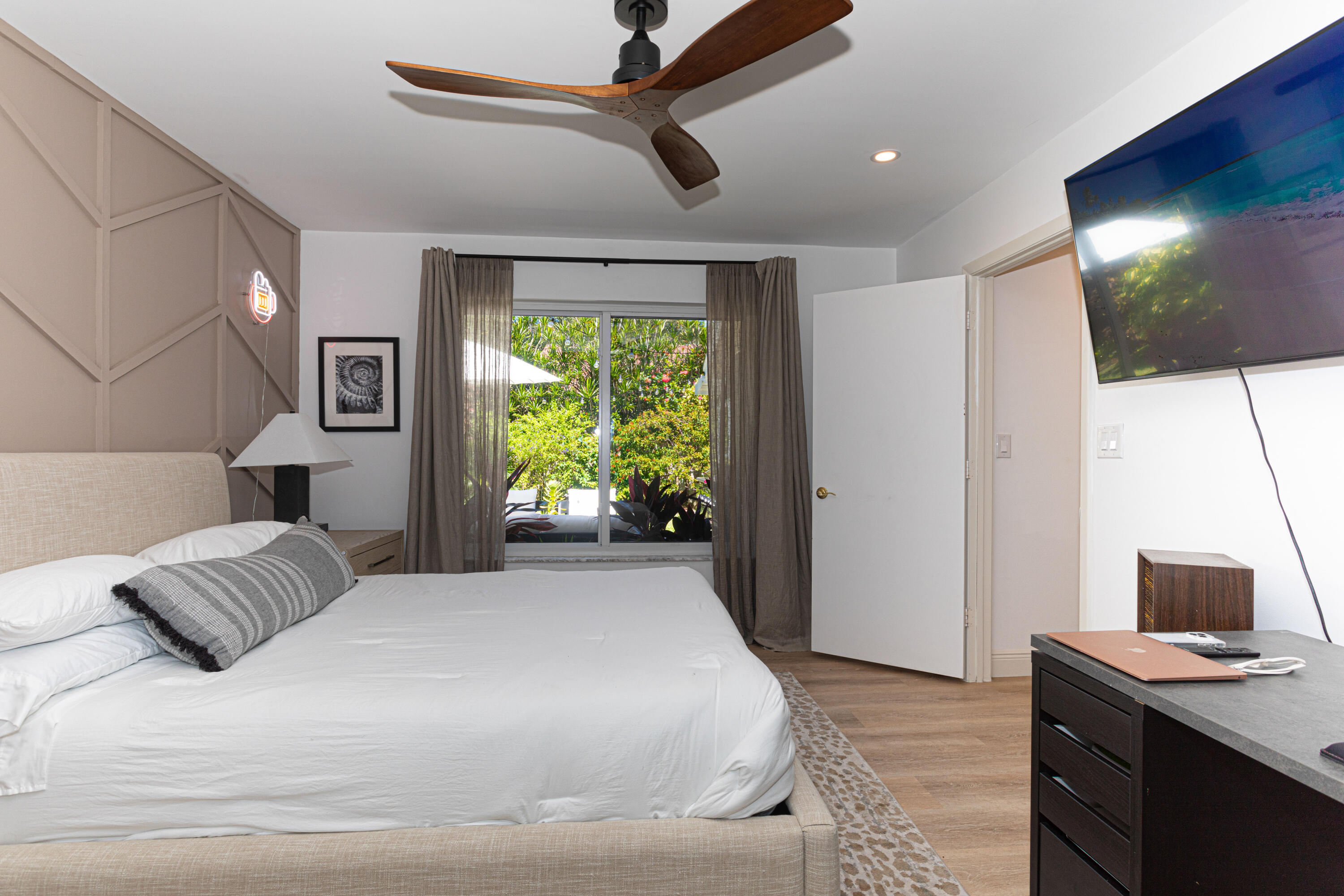 2477 Par Circle Delray Beach, FL 33445 - Photo 23 of 34 a bedroom with a bed and a flat tv screen