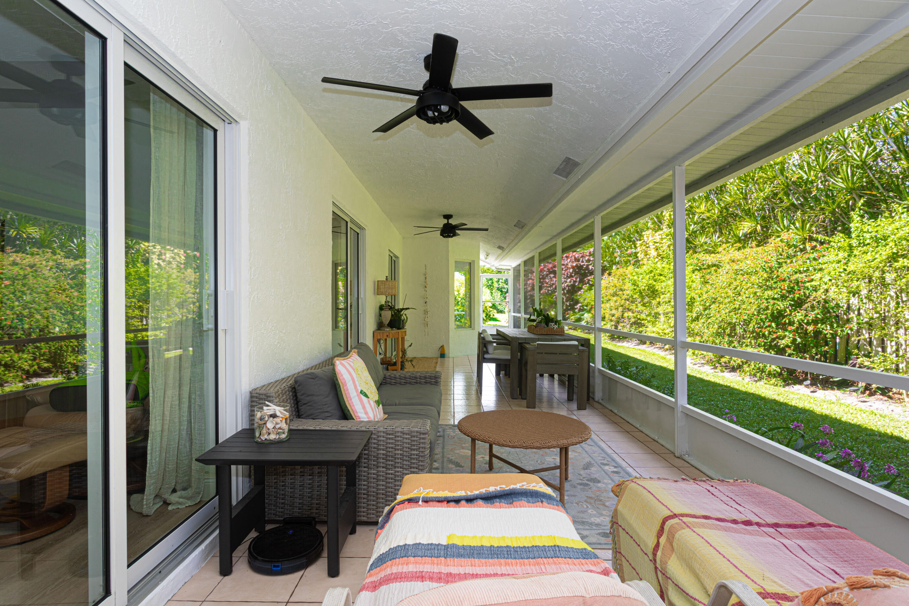 2477 Par Circle Delray Beach, FL 33445 - Photo 28 of 34 a living room with patio furniture and a floor to ceiling window