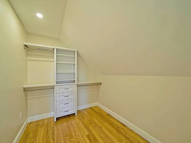 a view of walk in closet with empty racks