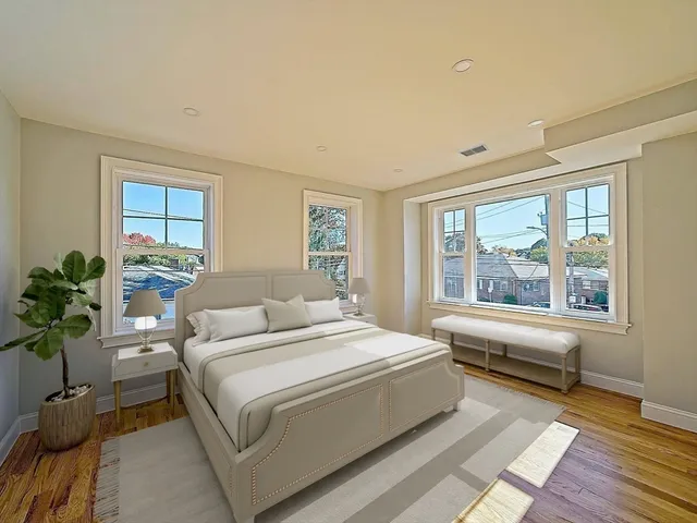 a bedroom with a large bed and a window
