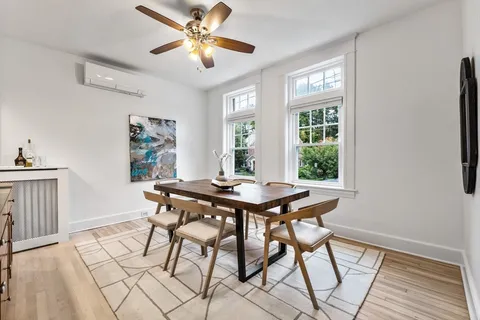 a view of a dining room with furniture window and wooden floor