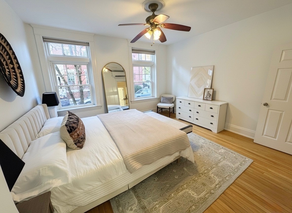 151 Longwood Avenue, Unit 1 Brookline, MA 02446 - Photo 14 of 34 a bedroom with a bed and wooden floor
