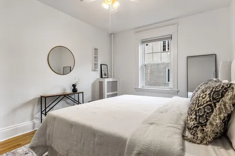 a bedroom with a bed and a chandelier