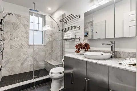 a bathroom with a sink toilet and shower