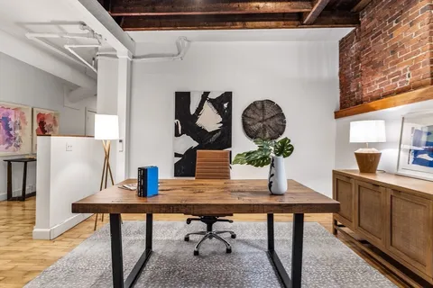 a view of a workspace with furniture