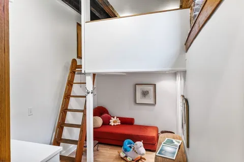 a living room with furniture and stairs