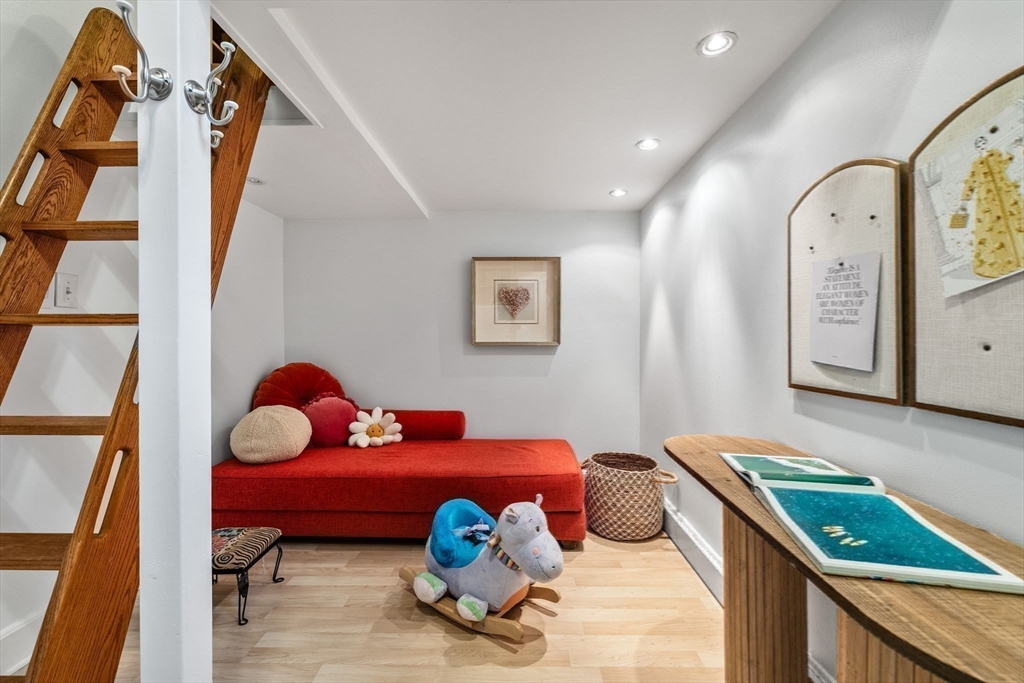 151 Longwood Avenue, Unit 1 Brookline, MA 02446 - Photo 25 of 34 a bedroom with baby bed toys and paintings on the wall