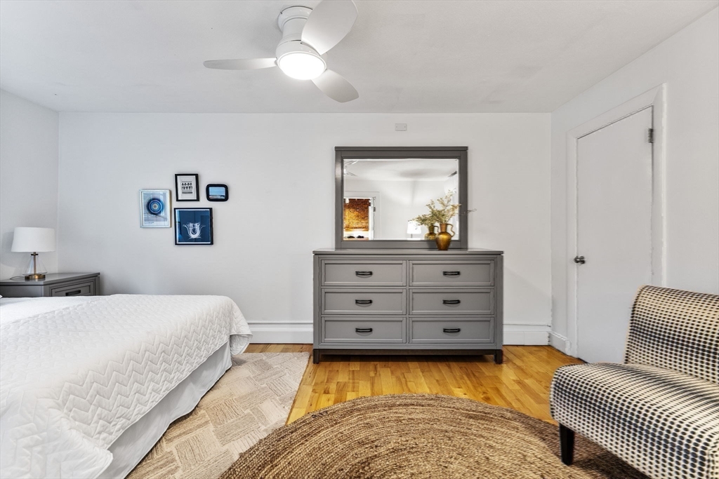 151 Longwood Avenue, Unit 1 Brookline, MA 02446 - Photo 28 of 34 a bedroom with a bed and a dresser
