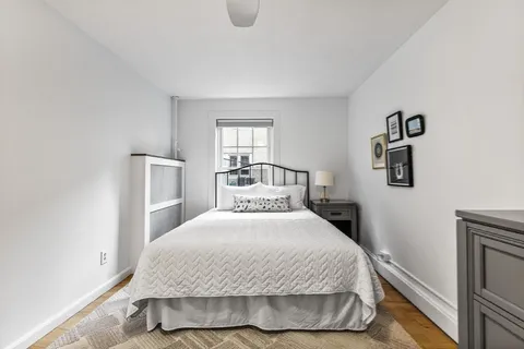 a bedroom with a bed and window