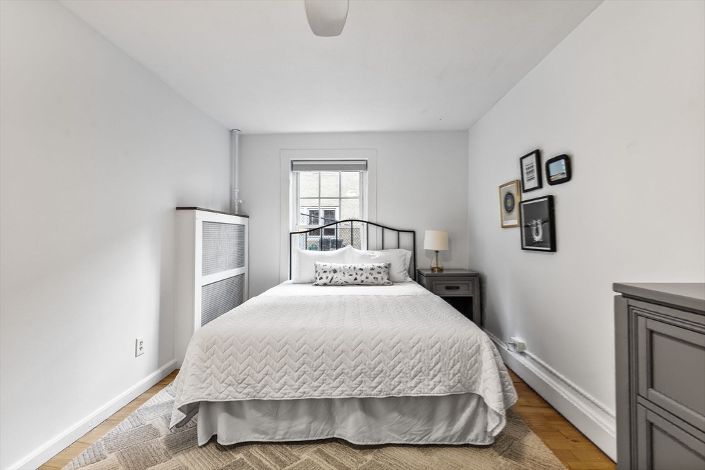 151 Longwood Avenue, Unit 1 Brookline, MA 02446 - Photo 29 of 34 a bedroom with a bed and window