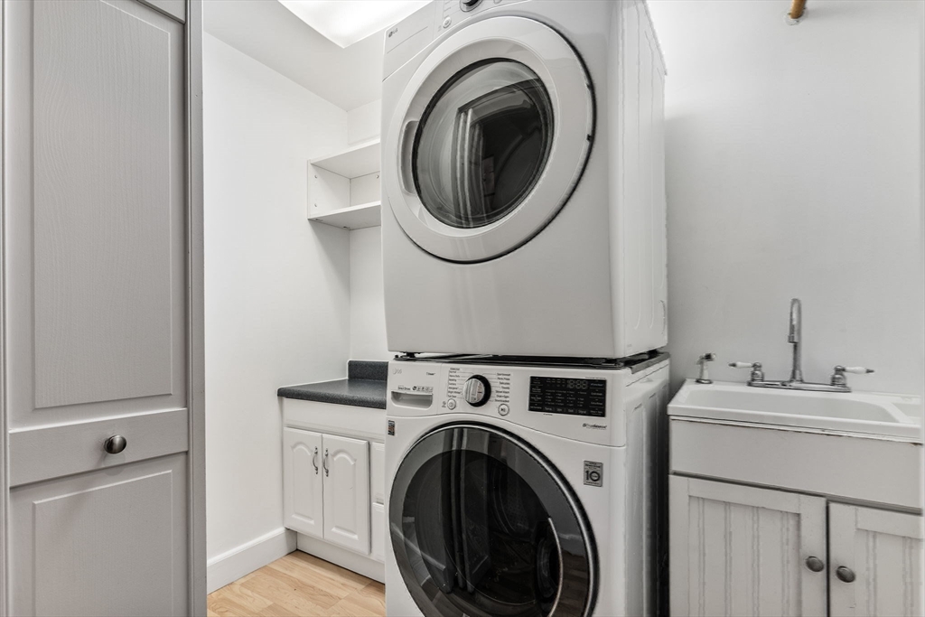 151 Longwood Avenue, Unit 1 Brookline, MA 02446 - Photo 31 of 34 a utility room with dryer and washer