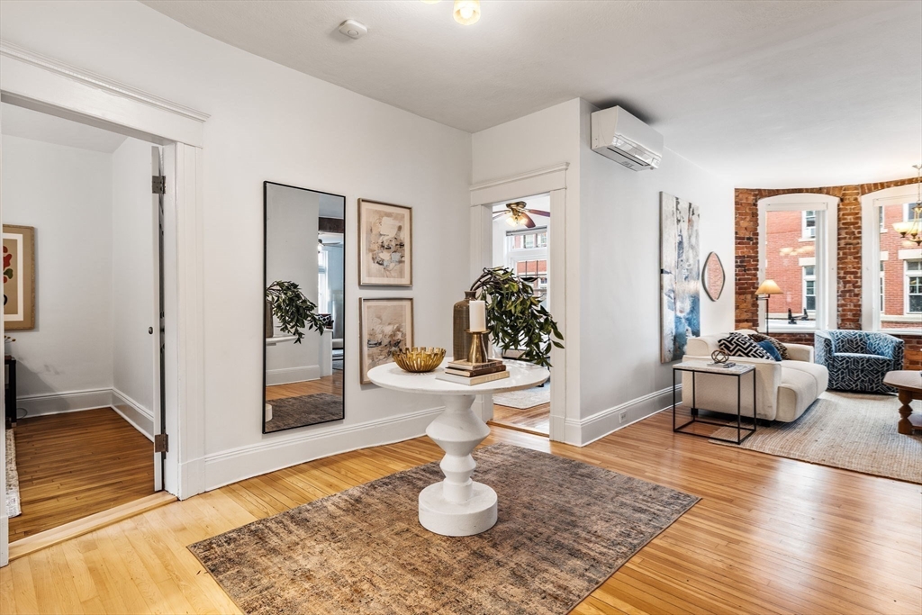 151 Longwood Avenue, Unit 1 Brookline, MA 02446 - Photo 7 of 34 a living room with furniture and a rug