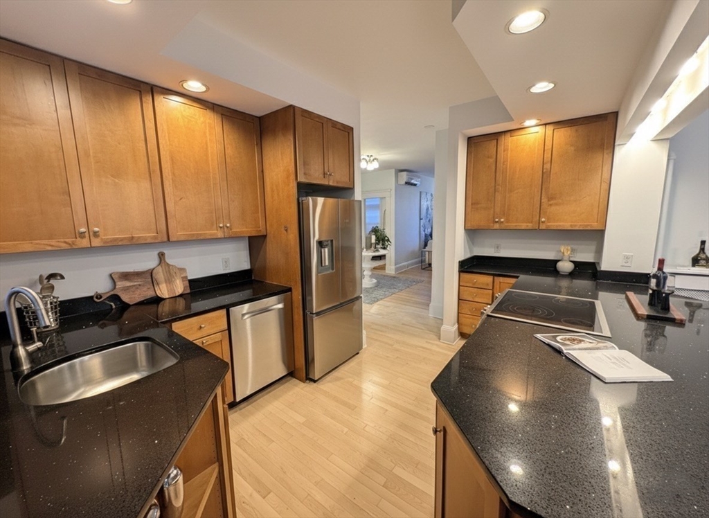 151 Longwood Avenue, Unit 1 Brookline, MA 02446 - Photo 8 of 34 a kitchen with stainless steel appliances granite countertop a sink a stove and a refrigerator
