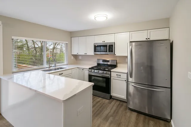 a kitchen with a refrigerator a stove and a sink