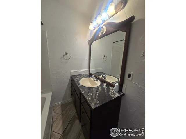 a living room with furniture and a mirror