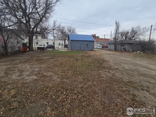 a view of a big yard with large trees