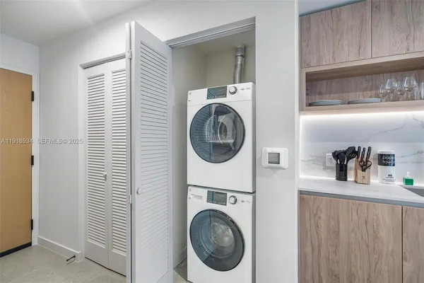 a close view of a utility room with dryer and washer