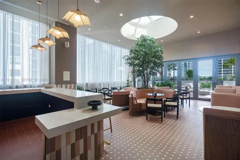 a kitchen with a table chairs and a chandelier