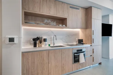 a kitchen with stainless steel appliances a sink stove and microwave