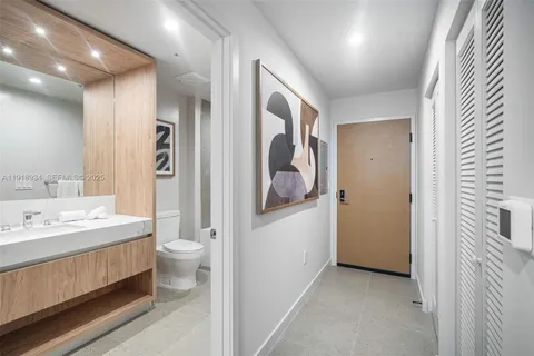 a bathroom with a double vanity sink toilet and shower
