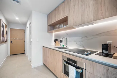 a kitchen with a sink and cabinets