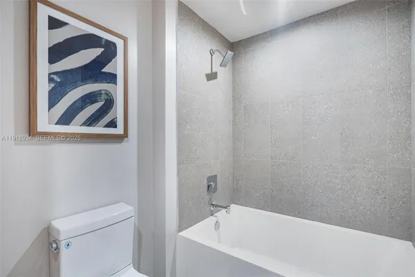 a bathroom with a bathtub and a toilet