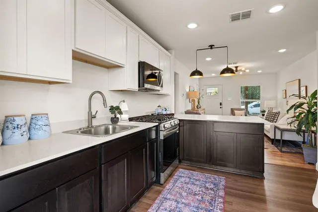 a kitchen with sink cabinets and wooden floor