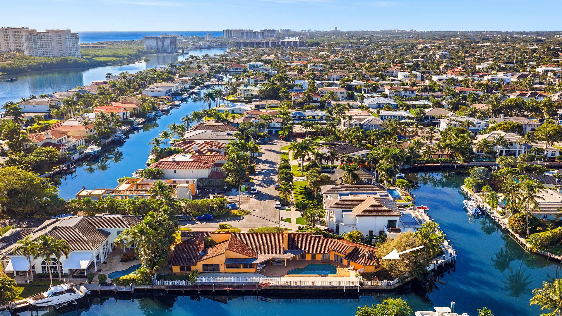 7401 Northeast Bay Cove Court Boca Raton, FL 33487 - Photo 1 of 13 an aerial view of residential houses with outdoor space and swimming pool