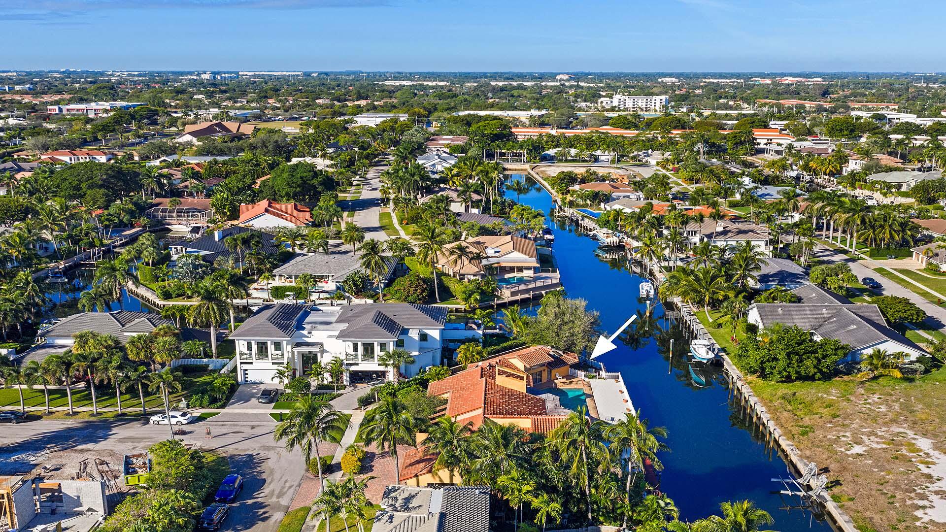 7401 Northeast Bay Cove Court Boca Raton, FL 33487 - Photo 6 of 13 an aerial view of residential houses with outdoor space and trees