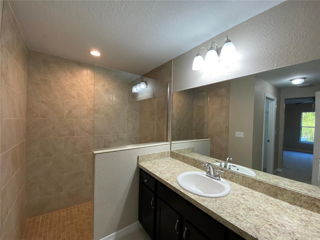 5366 Southwest 197th Terrace Dunnellon, FL 34431 - Photo 17 of 29 a bathroom with a granite countertop sink and a mirror