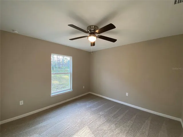 a view of an empty room and a window