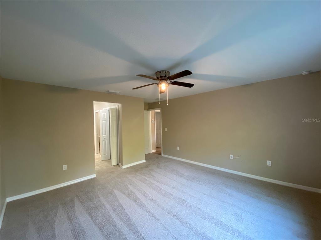 5366 Southwest 197th Terrace Dunnellon, FL 34431 - Photo 24 of 29 an empty room with wooden floor and windows