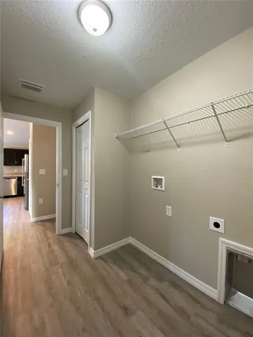 an empty room with a fireplace and cabinet