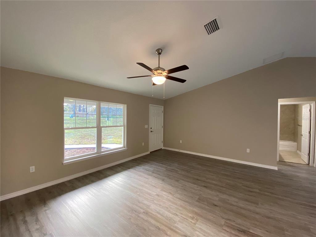 5366 Southwest 197th Terrace Dunnellon, FL 34431 - Photo 3 of 29 a view of an empty room with wooden floor and a window