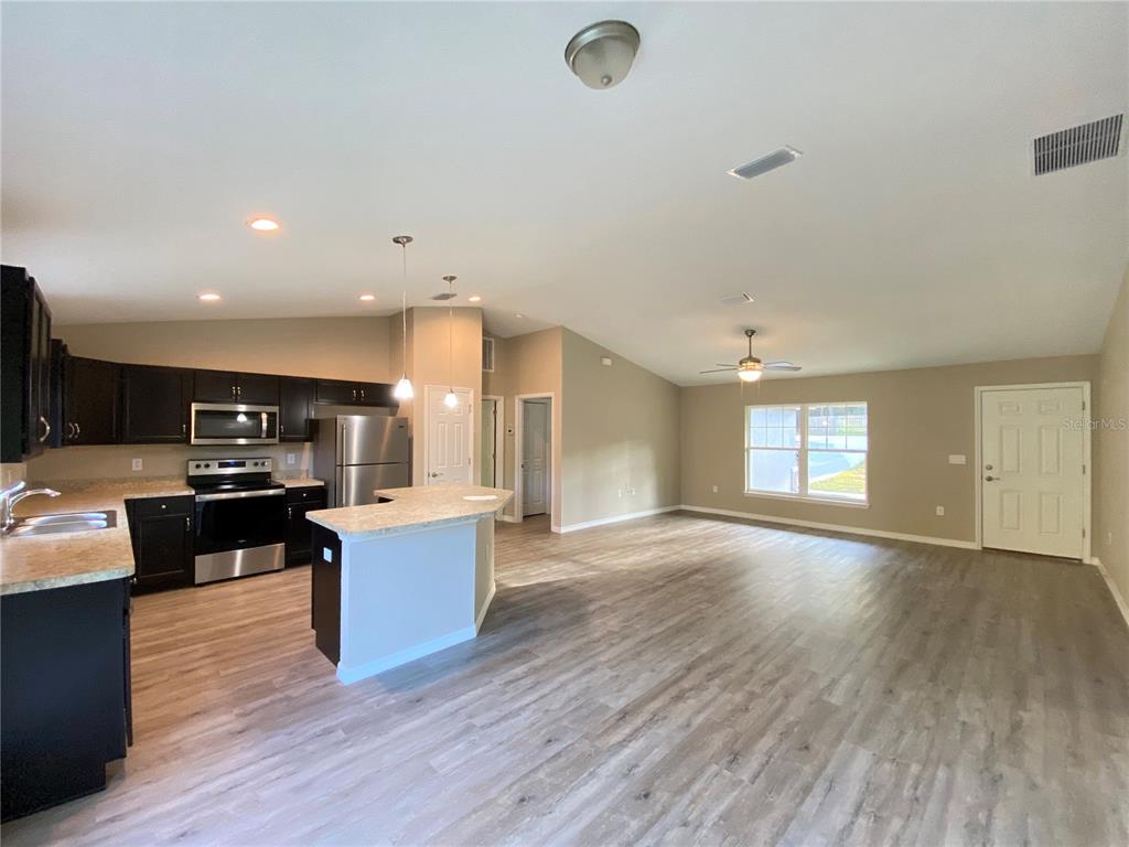 5366 Southwest 197th Terrace Dunnellon, FL 34431 - Photo 6 of 29 a living room with hard wood floors and kitchen