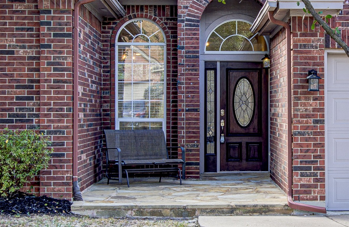 Property entrance featuring brick siding