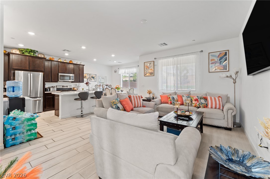 8879 Roadrunner Ravine Street Las Vegas, NV 89166 - Photo 14 of 39 An open concept living area seamlessly connects the well-appointed kitchen to a comfortable lounge space.