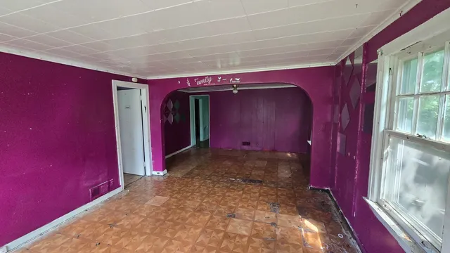 a view of a room with red walls and a window