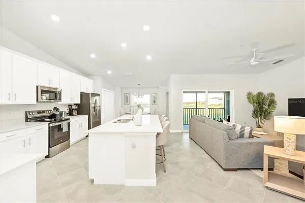 a kitchen with stainless steel appliances a sink and a refrigerator