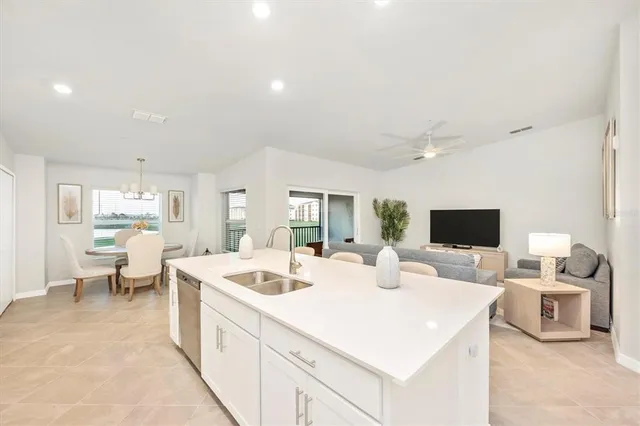 a living room with furniture and kitchen view