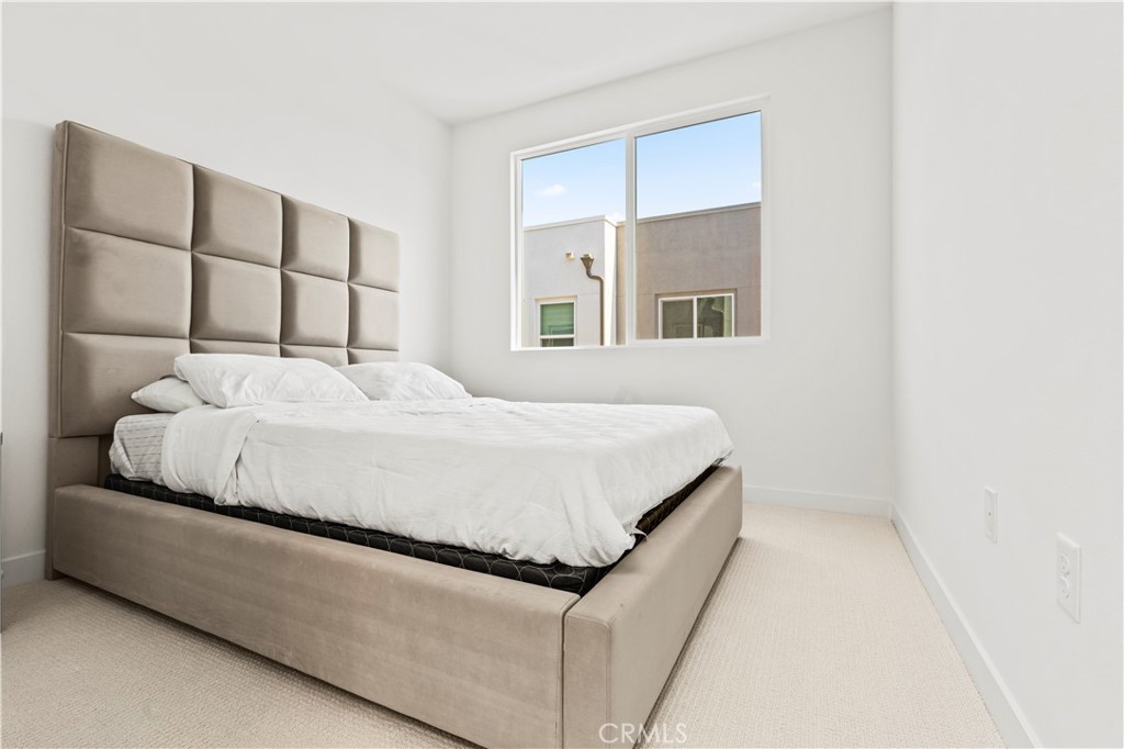 609 South Lyon Street Santa Ana, CA 92705 - Photo 18 of 52 a bedroom with a bed and a window