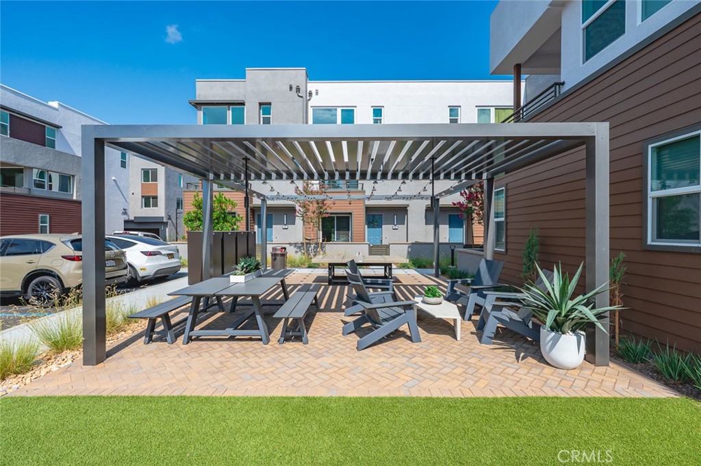 609 South Lyon Street Santa Ana, CA 92705 - Photo 36 of 52 a view of a patio with table and chairs potted plants with wooden fence