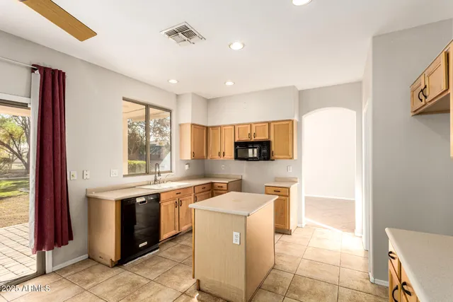 a kitchen with stainless steel appliances granite countertop a sink counter space and cabinets