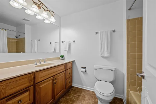 a spacious bathroom with a toilet sink and mirror