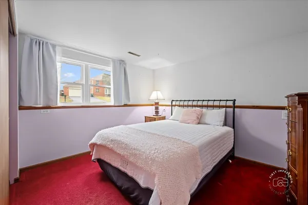 a bedroom with a bed and window