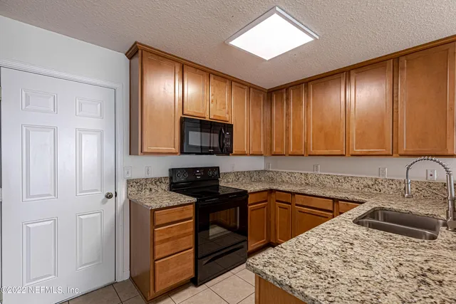 a kitchen with a sink stove and cabinets
